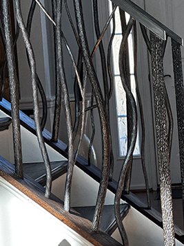 Aluminum spindles installed on decorative interior stair railing