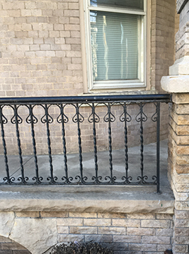 Face mount deck balusters installed on exterior stone railing