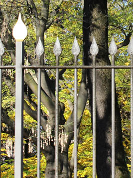 Gothic fence pickets with pointed spear tops in ornamental metal fence
