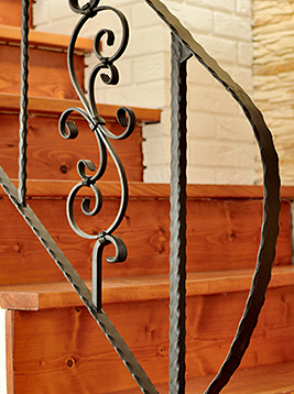 Hammered newel posts with decorative iron scroll railing