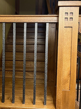 Interior balusters installed on residential wood staircase railing