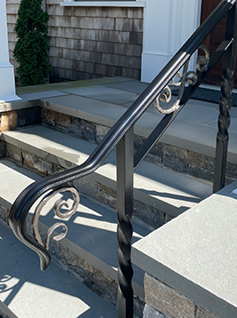 Metal balusters installed on exterior stone stair railing