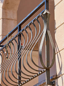 Metal deck pickets with curved modern railing design on exterior balcony
