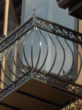 Metal deck railing balusters installed on decorative exterior balcony