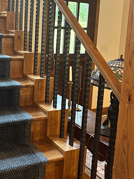 Metal spindles installed on interior staircase railing