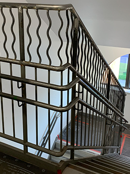 Modern stair spindles with curved metal design on staircase