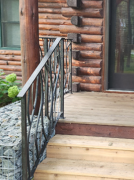 Porch railing balusters installed on rustic exterior log cabin porch