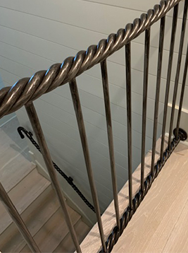 Round aluminum balusters installed on interior stair railing
