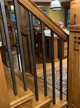 Square aluminum balusters installed on interior wood staircase