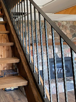 Stair spindles installed on interior wood staircase railing