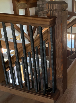 Steel balusters installed on interior wood railing system