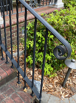 Steel stair balusters installed on exterior brick staircase