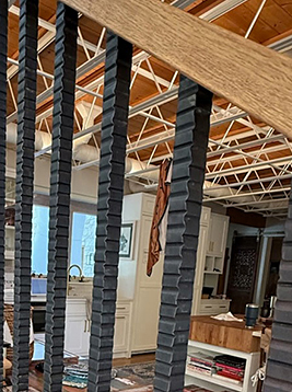 Textured balusters installed on interior wood staircase railing