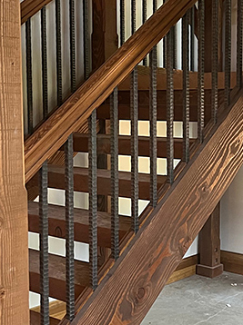 Textured spindles installed on interior wood stair railing