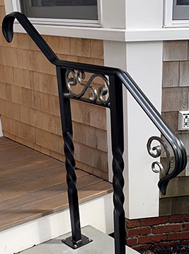 Twisted balusters with decorative iron scroll design on stair railing