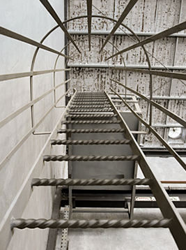 Twisted ladder rungs installed on industrial metal ladder system