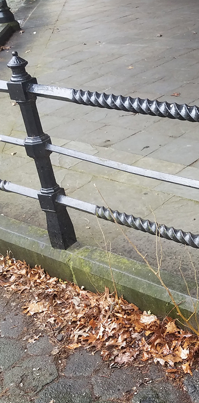 Twisted square bars installed in exterior metal railing system