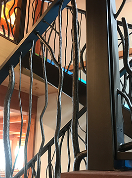 Wood grain newel posts installed on interior stair railing