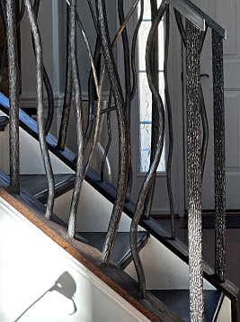 Wood grain newel posts installed on interior stair railing