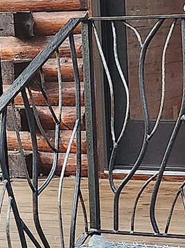 Wood grain square metal bar installed on log cabin porch railing