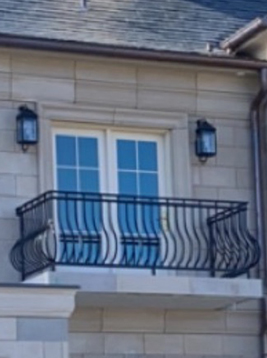 Wrought iron deck spindles installed on exterior balcony railing