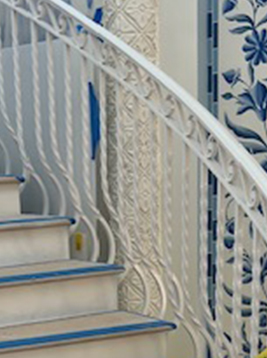 Wrought iron spindles installed on curved interior staircase