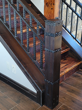 Wrought iron stair balusters installed on interior wood stairs