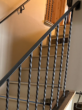 Wrought iron stair spindles installed on interior staircase