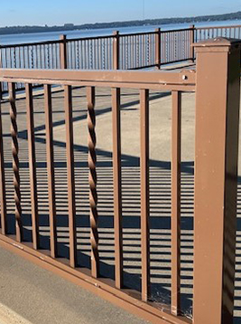 Outdoor metal railing with twisted balusters detail showing installed decorative spindles in exterior railing system
