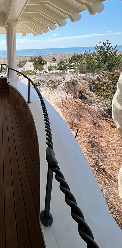 2 strand rope metal railing installed on curved exterior balcony