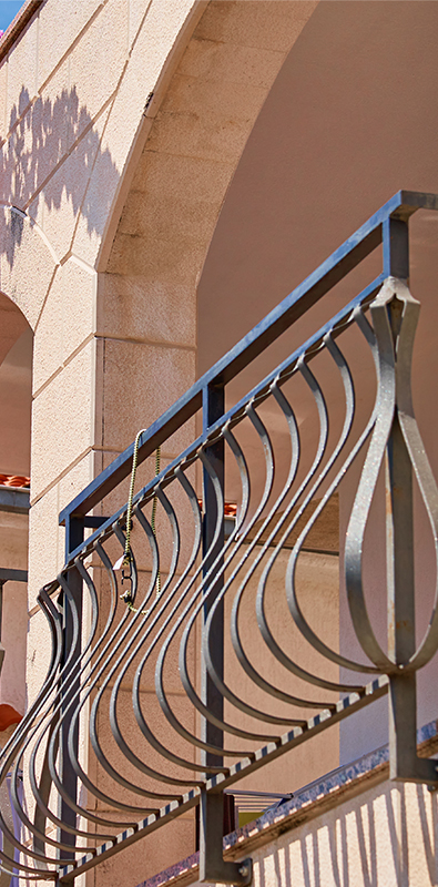 Metal deck pickets with curved modern railing design on exterior balcony
