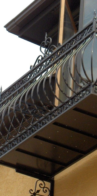 Metal deck railing balusters installed on decorative exterior balcony