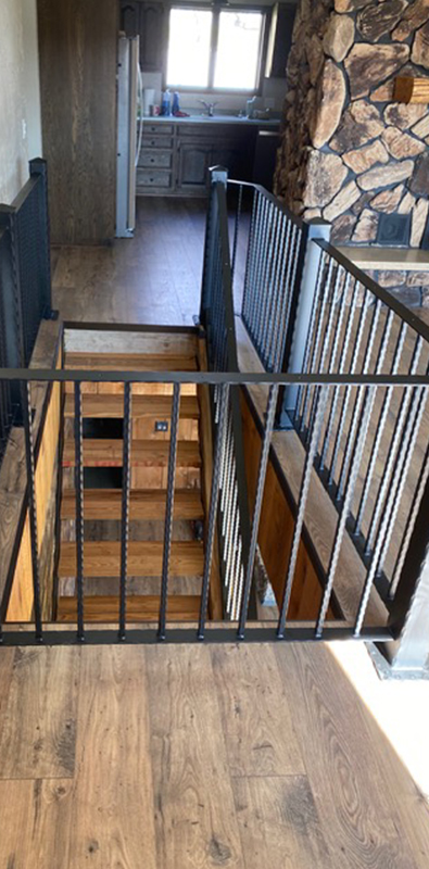 Metal railing balusters installed on interior stair landing