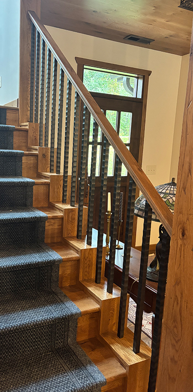 Metal spindles installed on interior staircase railing