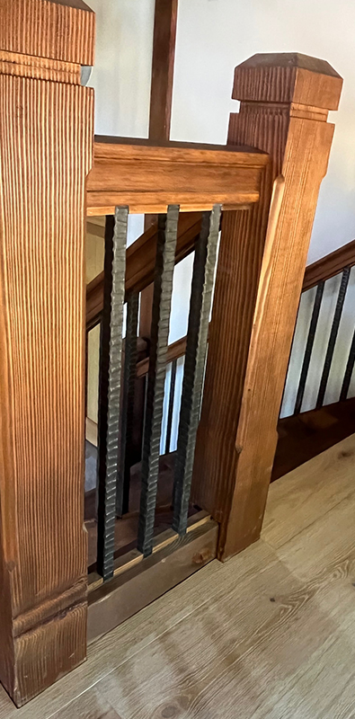 Metal stair balusters installed on traditional wood staircase