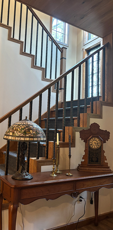 Metal stair spindles installed on interior wood staircase railing