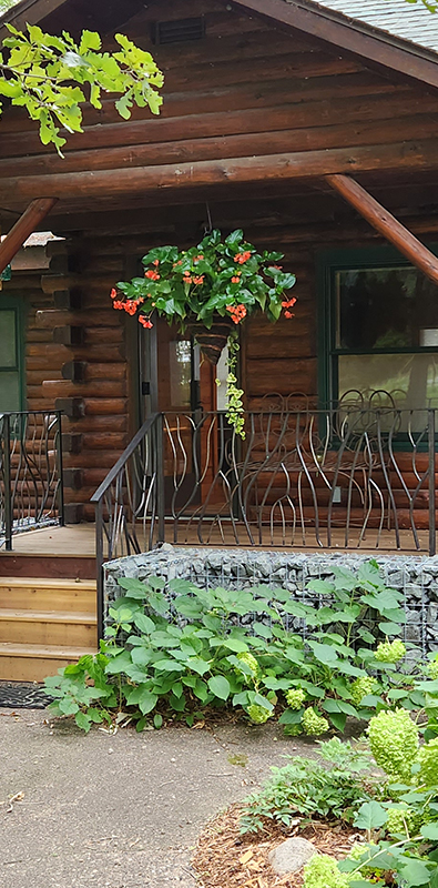 Porch spindles installed on rustic exterior log cabin porch