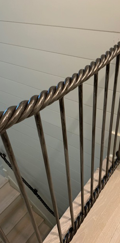 Round aluminum balusters installed on interior stair railing
