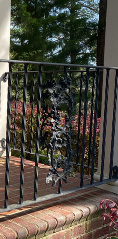 Square metal deck balusters installed on exterior brick balcony