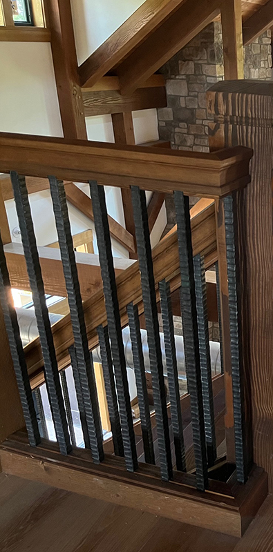 Steel balusters installed on interior wood railing system