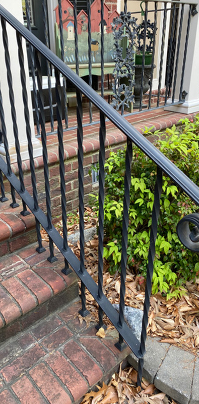 Steel stair balusters installed on exterior brick staircase