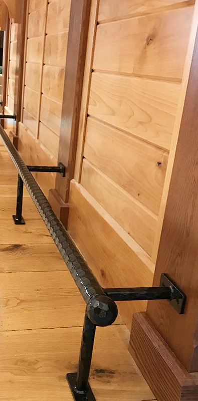 Textured round bar installed as horizontal stair railing support