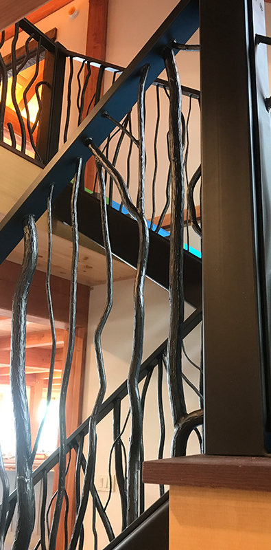 Wood grain newel posts installed on interior stair railing