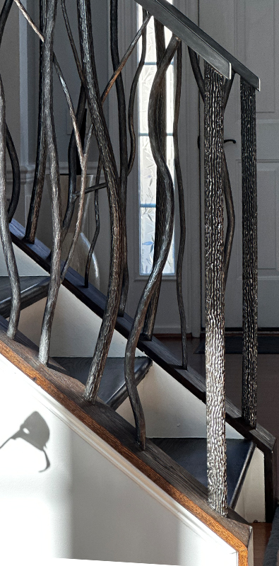 Wood grain newel posts installed on interior stair railing