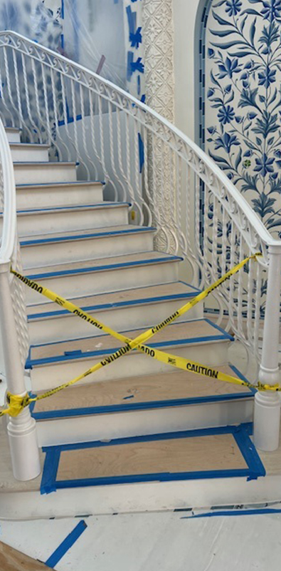 Wrought iron spindles installed on curved interior staircase