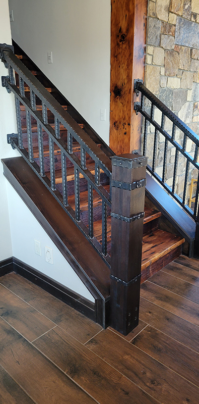 Wrought iron stair balusters installed on interior wood stairs