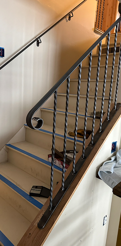 Wrought iron stair spindles installed on interior staircase